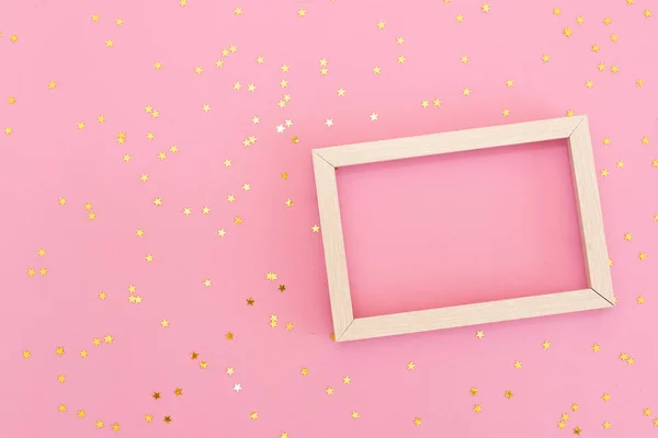 Photo frame mock up with space for text, golden sequins confetti on pink background. Lay Flat, top view. Valentine\'s minimal flatly background.