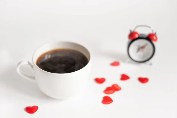 Alarm clock and coffee placed on the table