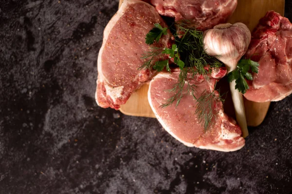 Raw fresh marbled meat Steak and seasonings on dark marble background