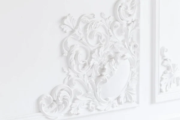Beautiful ornate white decorative plaster moldings in studio Royalty Free Stock Images