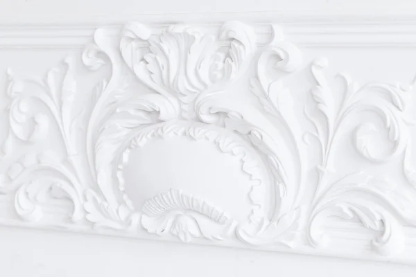 Beautiful ornate white decorative plaster moldings in studio Stock Photo