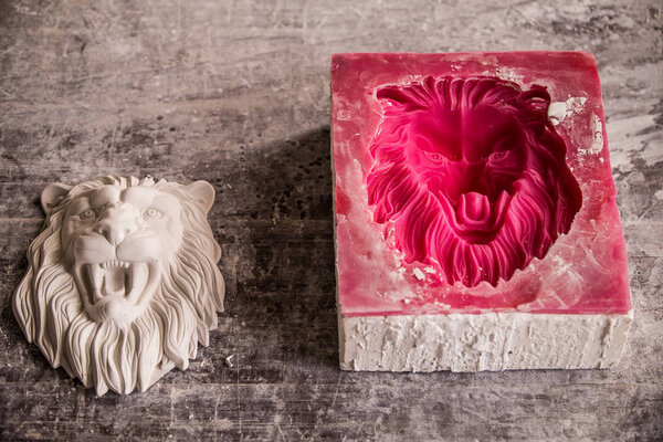 Plaster workshop. Separates the silicone mold from the plaster sculpture of the lions head.