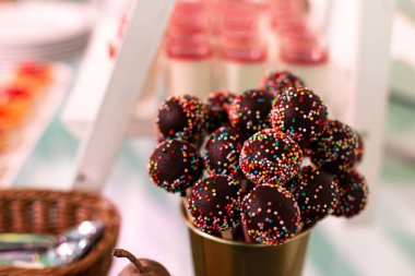 Candy bar. Sweets on a stick with sprinkles. Selective focus.