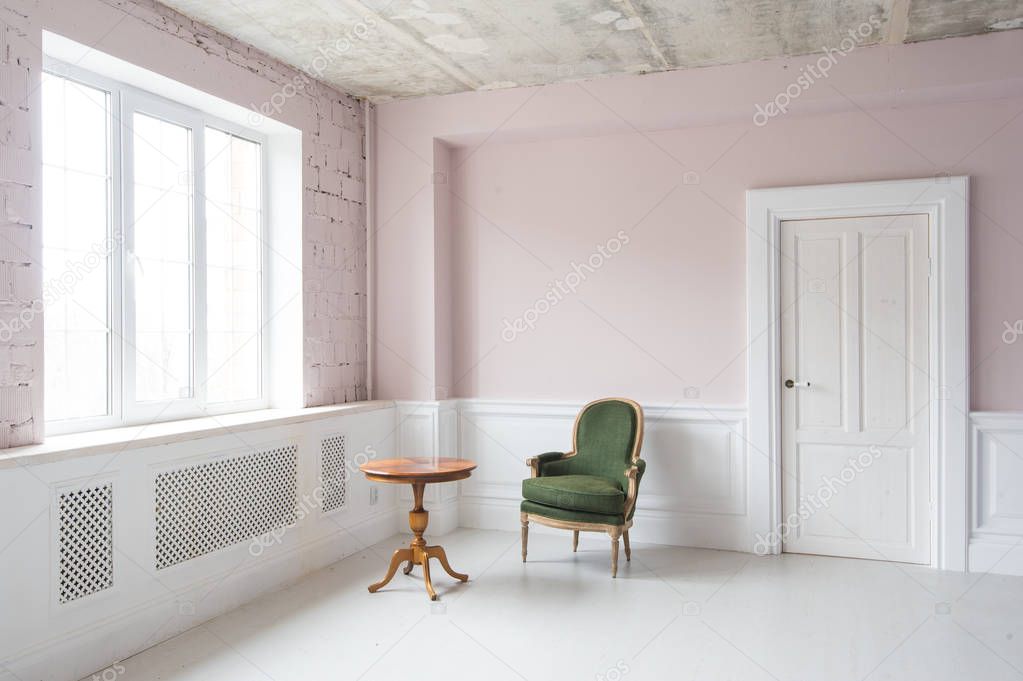 Elegant interior in Baroque style with a vintage armchair and a table.