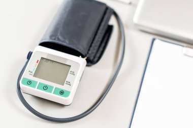 Ofiste ahşap masa üzerinde dizüstü bilgisayar, stetoskop ve dizüstü bilgisayar ile doktor İşyeri. Kan basıncı monitörü. Tıbbi ekipmanlar. Kardiyak tanı. vintage sesi.