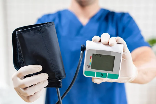 Cardiologist doctor holds the pressure test device, tonometer in hand. Medical object. — Stock Photo, Image