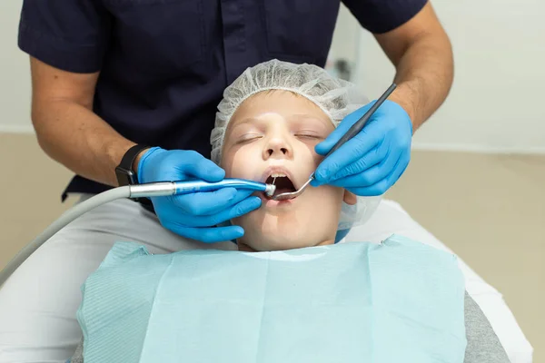Little boy lays under anesthesia on dentist coach