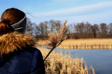 Nehirde çim ile el arayan kadın, Bahar