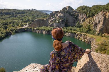 Danimarka 'nın Bornholm adasında kayalarla çevrili bir göl. Elinde kamera olan Thyristine. Opalsoen, elinde kamera olan Thyristine. Kameraya bakan turist köpeği..