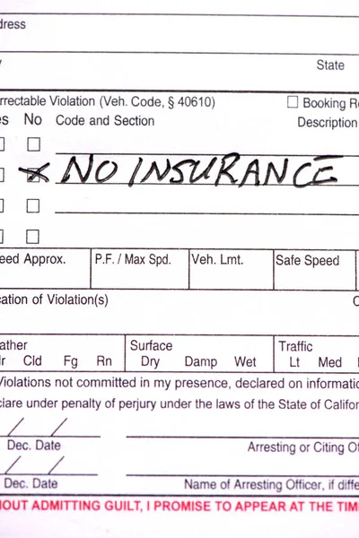 A close up of a traffic ticket for not having insurance.