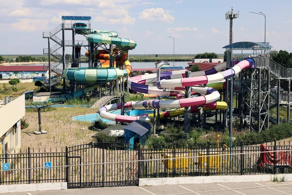 Abandoned water park is out of service in summer due to the covid-19 quarantine for the entire season. All areas are overgrown with grass when there is no maintenance and there are no people