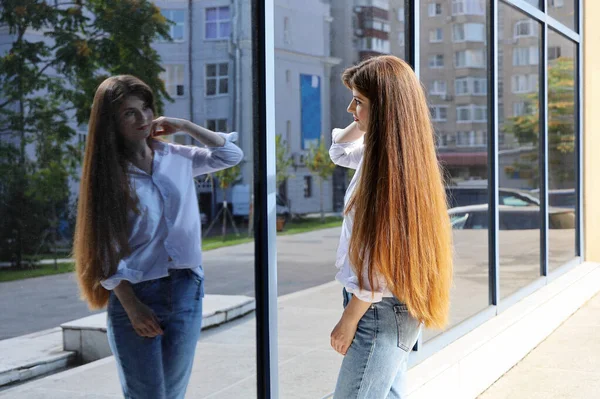 Young Woman Beautiful Long Hair Looks Herself Reflection Glass Wall — Stock Photo, Image