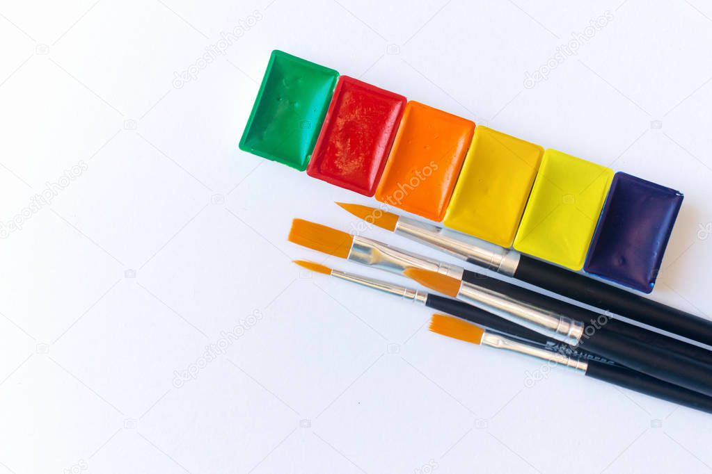 Photo of set of watercolor paints and brush for water color painting