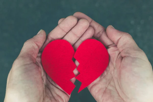 Broken heart in the hands - divorce concept — Stock Photo, Image