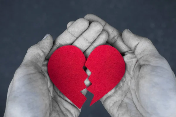 Broken heart in the hands - divorce concept. monochrome photo with red heart. Blak and white — Stock Photo, Image