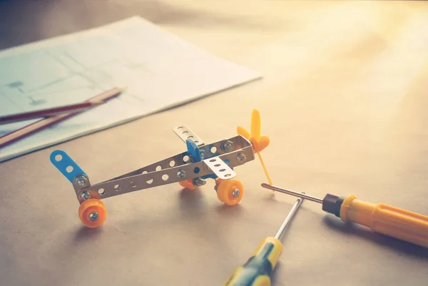 Toy iron plane with screwdrivers. Metal constructor. Dream, play and create — Stock Photo, Image