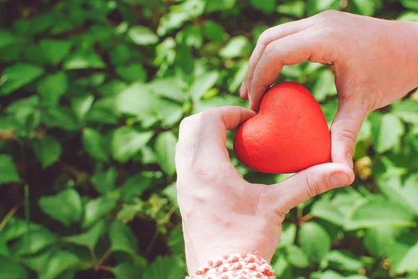 Концепция отношений и любви - крупным планом руки человека с красным сердцем — стоковое фото