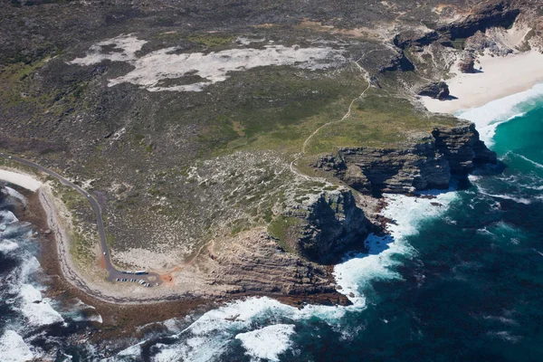 Aerial view of Cape point with lighthouse and Cape of Good Hope from a helicopter. Panorama of South Africa from birds eye view on a sunny day. Edge of the earth from helicopter view. — Stock Photo, Image