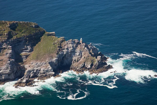 Aerial view of Cape point with lighthouse and Cape of Good Hope from a helicopter. Panorama of South Africa from birds eye view on a sunny day. Edge of the earth from helicopter view. — Stock Photo, Image