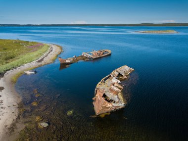Aerial view of abandoned and derelict rusty old ships near lonaly island in The Arctic Ocean. Russia. White Sea clipart