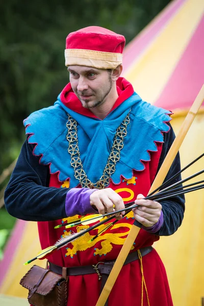 stock image Torzhok, Russia -August 15, 2020: Historical interpreters reconstruction in european medieval costume.Portrait of a man in an old historical dress with bow and arrows