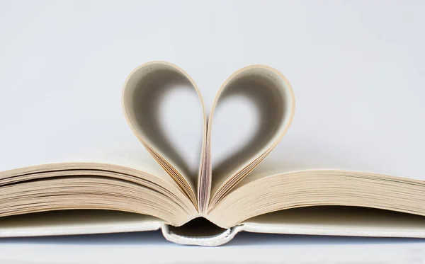 White book with pages that form a heart on white background. I love reading concept — 스톡 사진