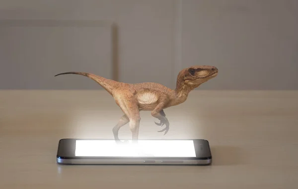 Smartphone projecting a 3d hologram of a velociraptor — Stock Photo, Image