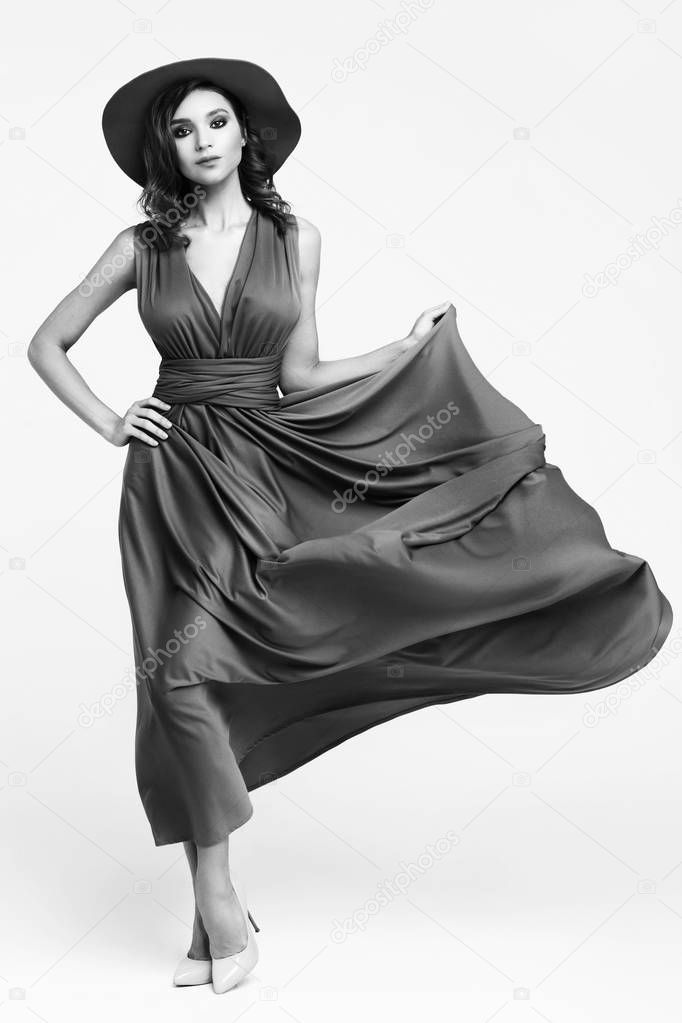 black and white fashion shot of young woman in elegant dress