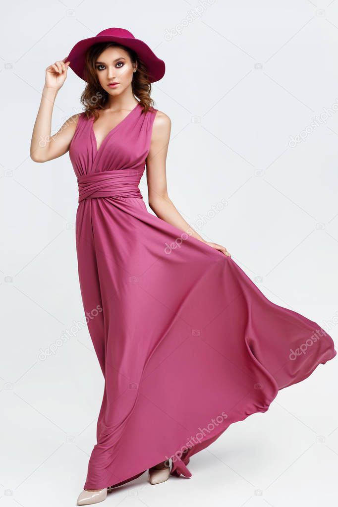 fashion shot of young woman in elegant pink dress