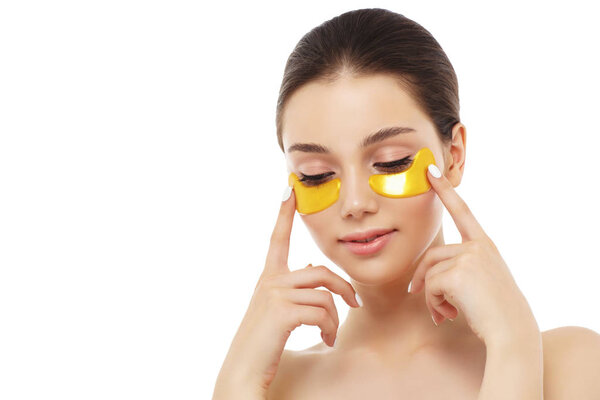 Woman face with golden mask under eyes, natural makeup 