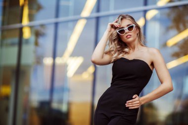 Siyah takım elbiseli genç bir kadının moda portresi.
