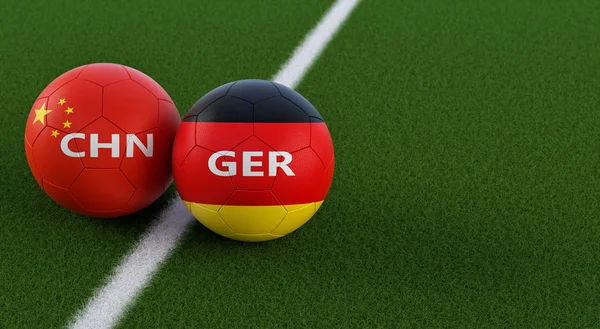 China vs. Germany Soccer Match - Soccer balls in Chinas and Germanys national colors on a soccer field. Copy space on the right side - 3D Rendering