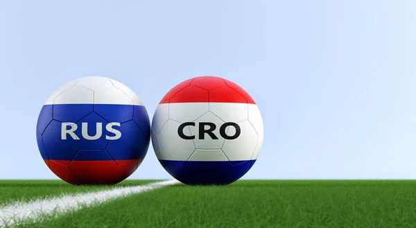 Croatia vs. Russia Soccer Match - Soccer balls in Croatia and Russias national colors on a soccer field. Copy space on the right side - 3D Rendering