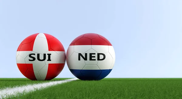 Netherlands vs. Switzerland Soccer Match - Soccer balls in Netherlands and Switzerland national colors on a soccer field. Copy space on the right side - 3D Rendering