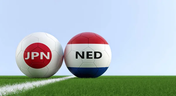 Japan vs. Netherland Soccer Match - Soccer balls in Japan and Netherlands national colors on a soccer field. Copy space on the right side - 3D Rendering
