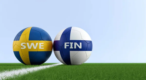 Sweden vs. Finland Soccer Match - Soccer balls in Sweden and Finlands national colors on a soccer field. Copy space on the right side - 3D Rendering