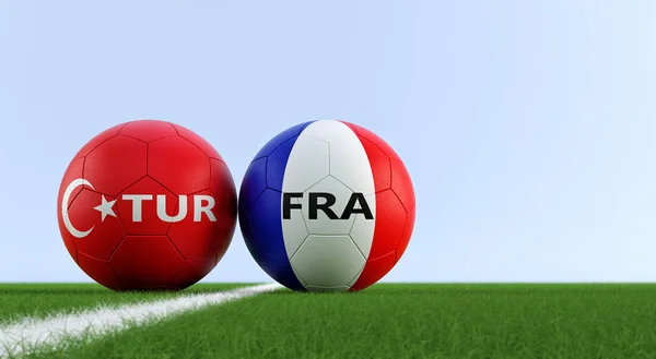 Turkey vs. France Soccer Match - Soccer balls in Turkey and France national colors on a soccer field. Copy space on the right side - 3D Rendering