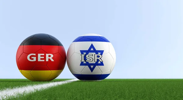 Israel vs. Germany Soccer Match - Soccer balls in Israel and Germany national colors on a soccer field. Copy space on the right side - 3D Rendering