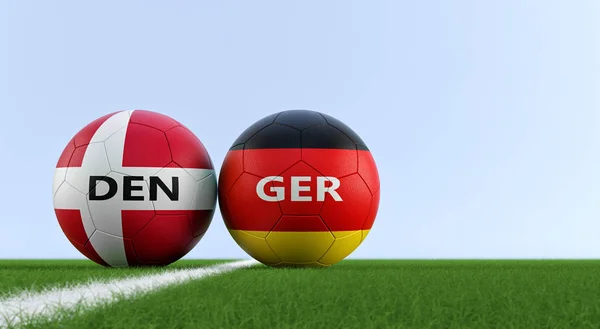 Germany vs. Denmark Soccer Match - Soccer balls in Germany and Denmark national colors on a soccer field. Copy space on the right side - 3D Rendering