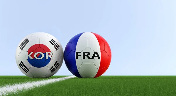 South Korea vs. France Soccer Match - Soccer balls in France and South Korea national colors on a soccer field. Copy space on the right side - 3D Rendering