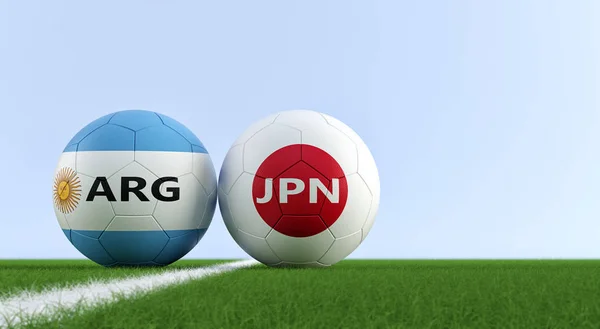 Argentina vs. Japan Soccer Match - Soccer balls in Argentina and Japan national colors on a soccer field. Copy space on the right side - 3D Rendering