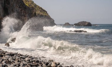 güçlü dalgalar denizde kayalar üzerinde kırmak