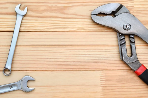 Manual, industrial repair tool on wooden table