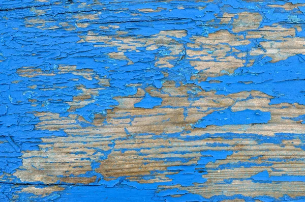 Texture of shabby, blue paint on an old wooden surface