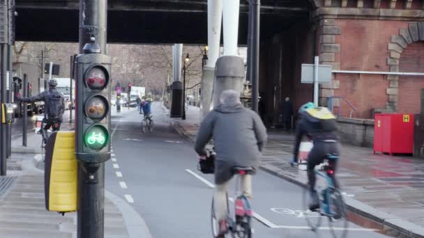 Rowerzystów jazda w cyklu zajęty lane w Londynie z cyklu światłach przez plac budowy — Wideo stockowe
