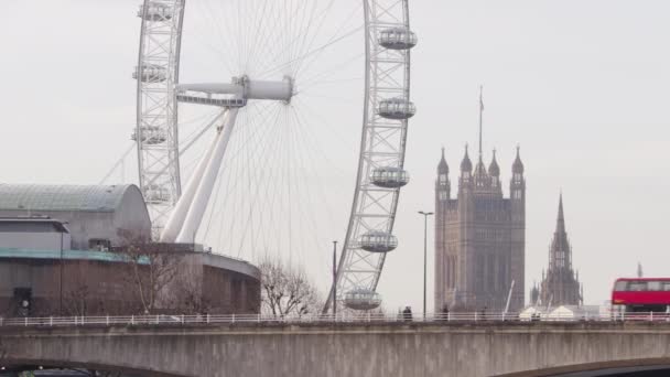 Los autobuses pasan por London Eye y Big Ben en Waterloo Bridge — Vídeos de Stock