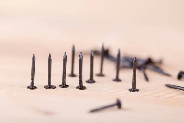 Nagels op houten tafel, tools en bouw concept — Stockfoto