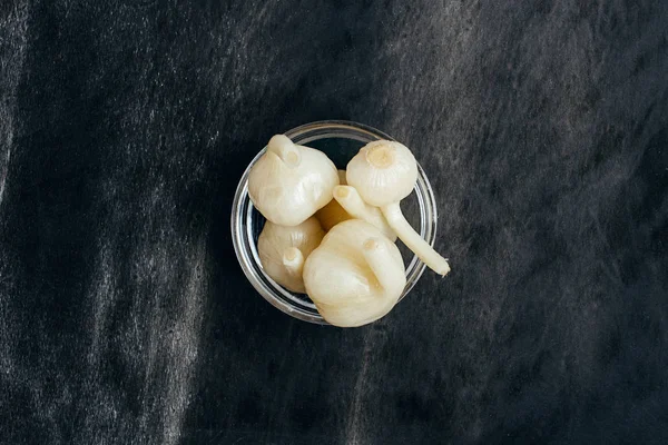 Eingelegter Knoblauch auf dunklem Hintergrund — Stockfoto