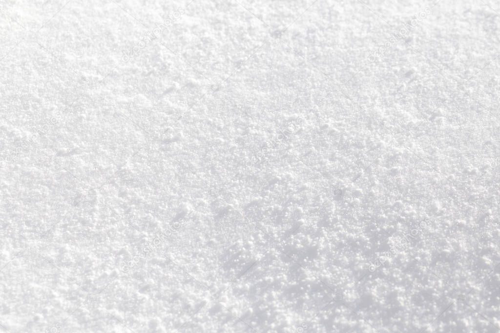 Texture of white snow sparkling in the sun. Background of fresh snow