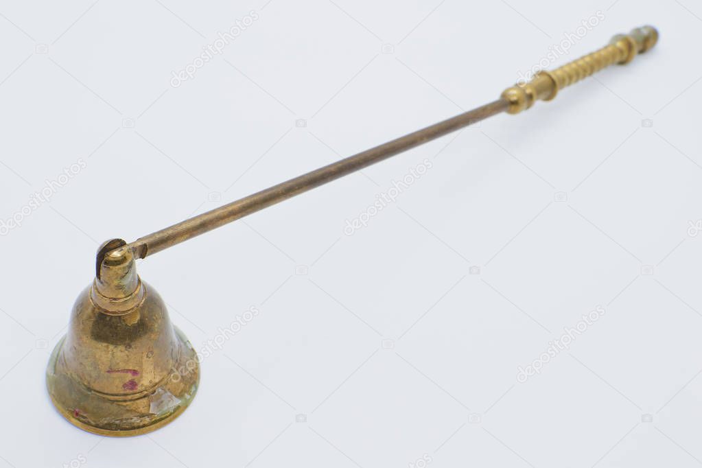 Closeup of an antique golden candles blaze on white background